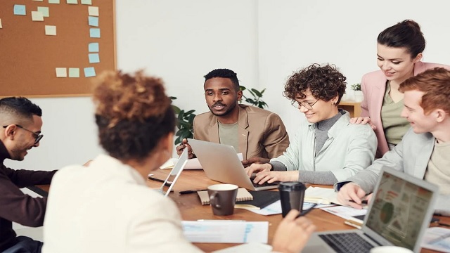 Workers working as a team, representing the goal of managing international teams