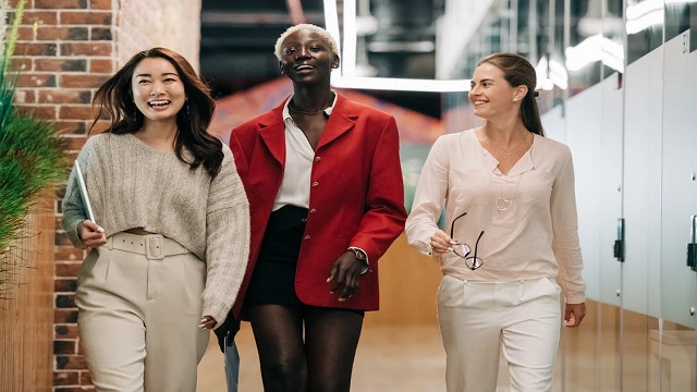 Three women of different ethnicities walking together