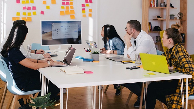 A group of people in a meeting developing a business improvement strategy